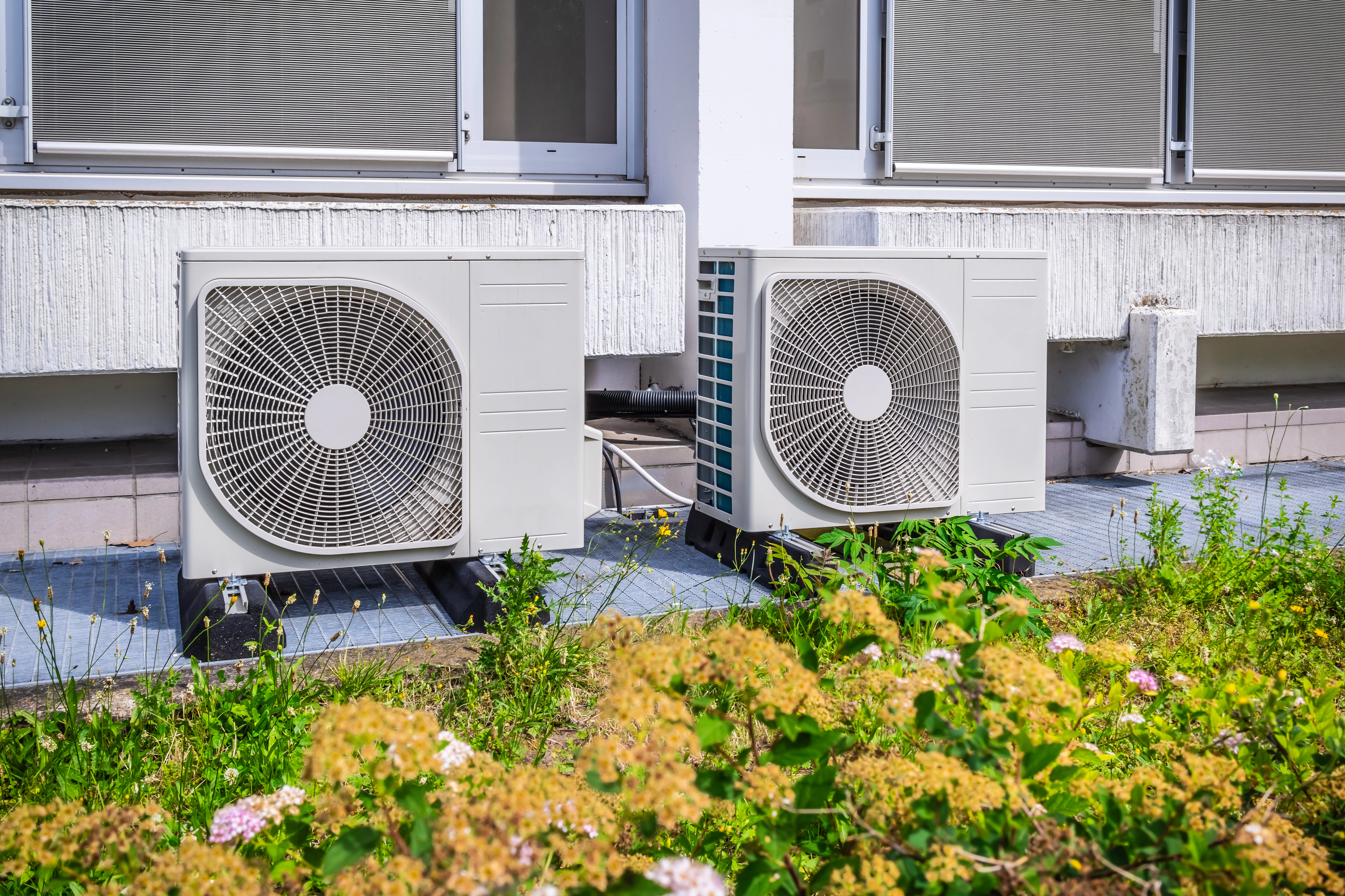 Modern air-source heat pump outside a home